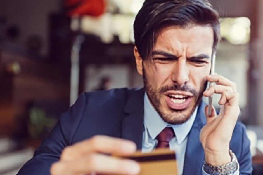 Man on Phone Holding Credit Card