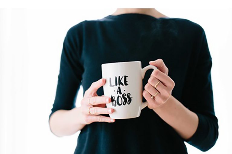 Woman with coffee mug that says Like A Boss.