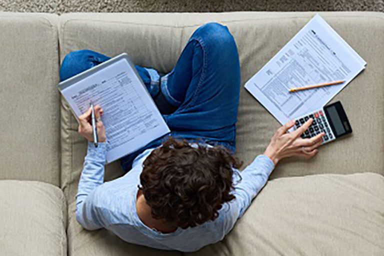 Person Doing Taxes on Couch